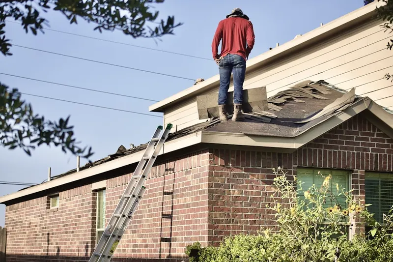Professional roofer working on a residential roof in Elmsford